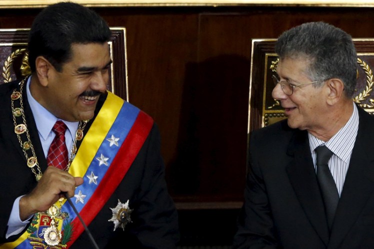 Venezuela's President Nicolas Maduro and Henry Ramos Allup, president of the National Assembly, smile during his annual report of the state of the nation in Caracas